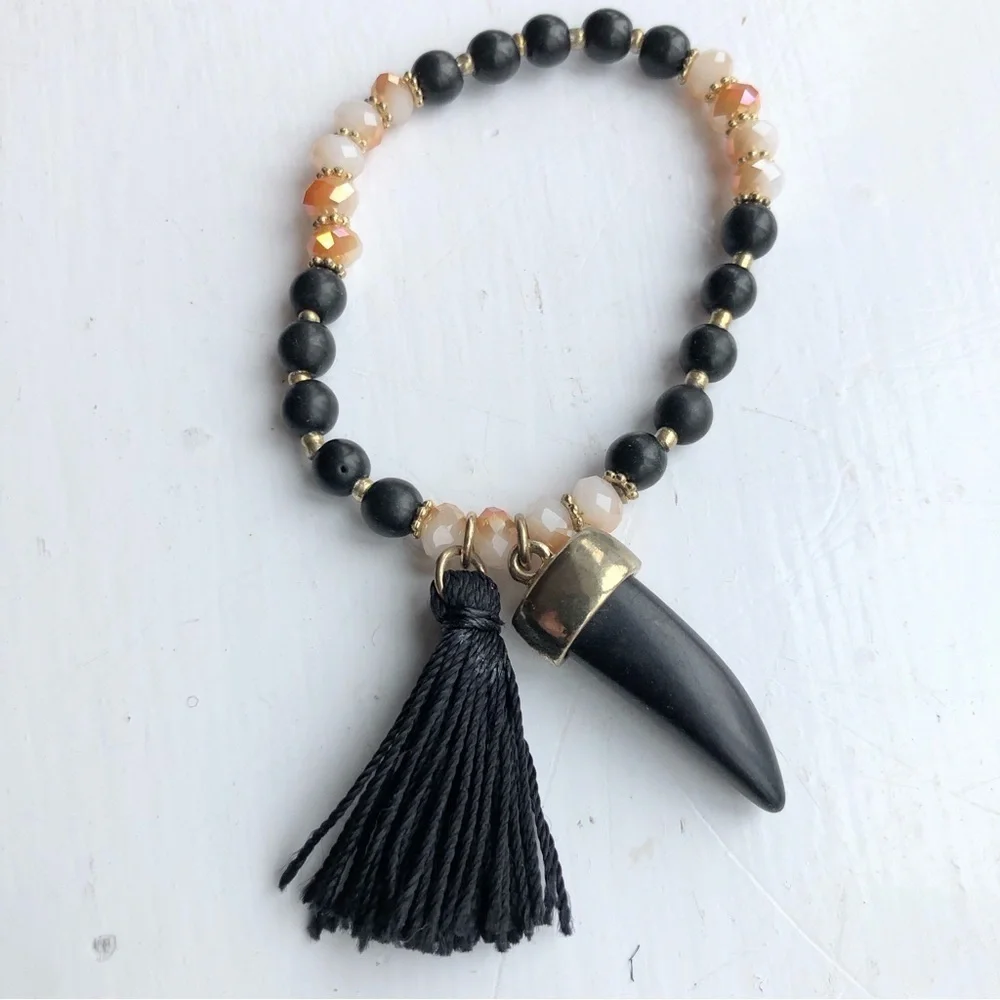 earthy neutral beaded horn tassel stretch bracelet
